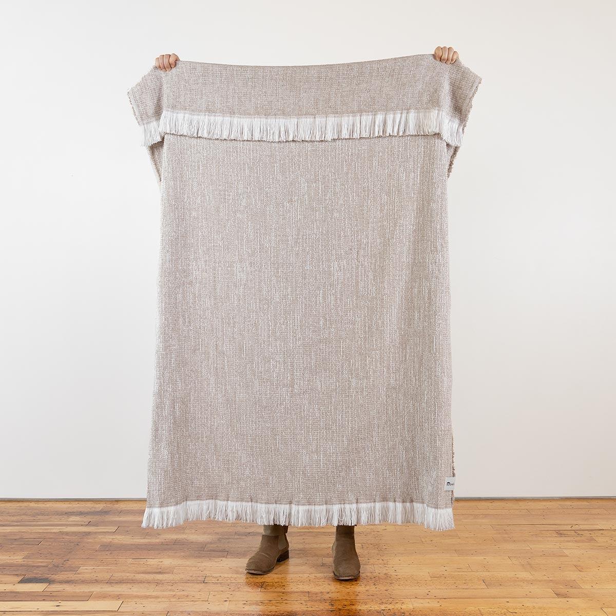 sunbrella-crosshatch-throw-flax-full-size-held-up-4_1d0e2c5b-8f38-41cf-8e92-2116b47de7e0.jpg